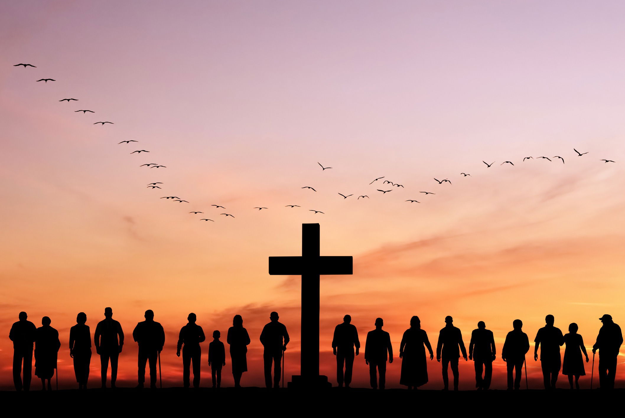A silhouette of a group of people standing in front of a cross at sunset, symbolizing unity and connection within the Christian community. The warm tones of the sky and the cross in the background represent faith, hope, and the collective mission of sharing the message of salvation.