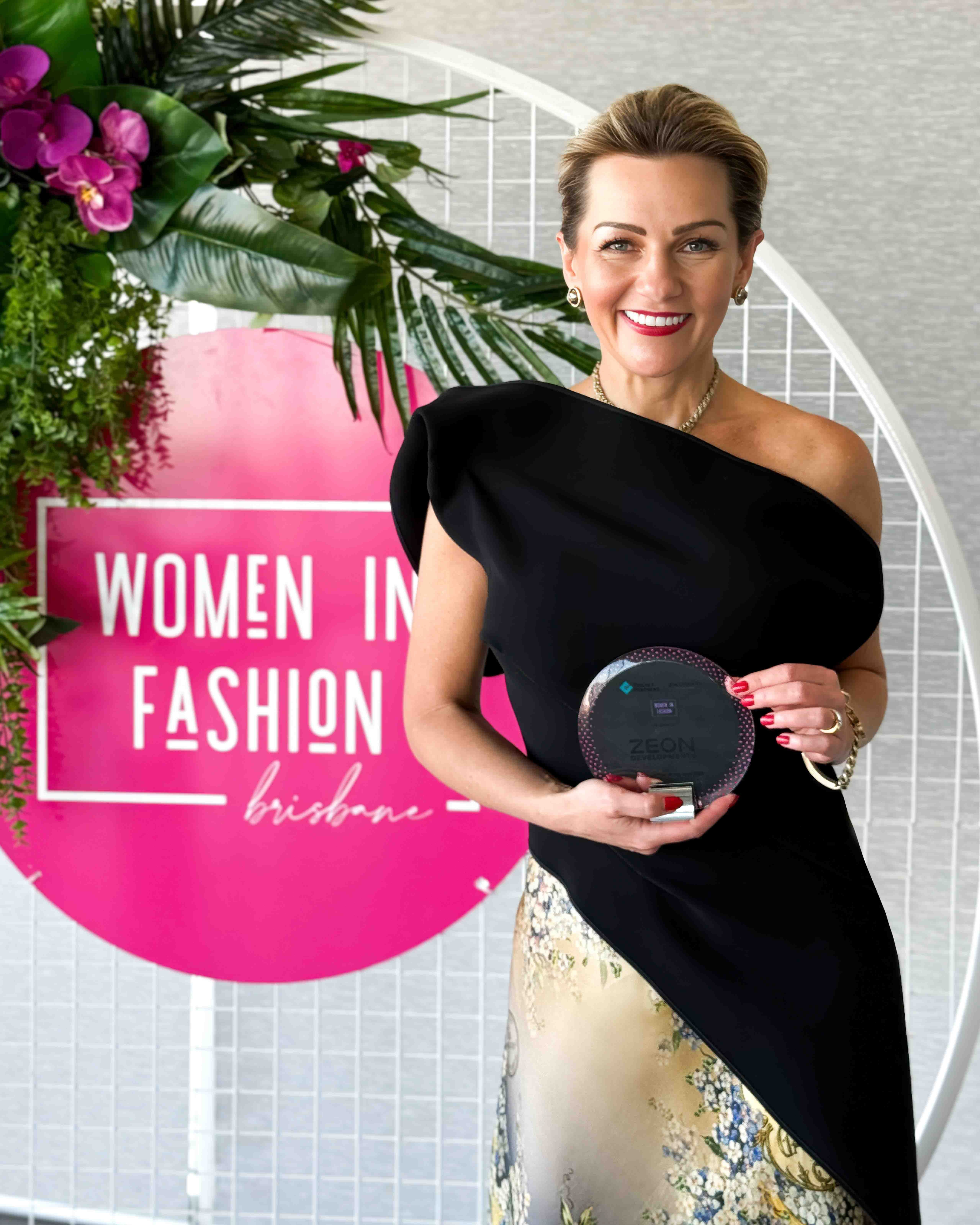 Vera Williams of VERAS Studio holding the Best Fashion Photographer of the Year award at the 2026 Women in Fashion Awards