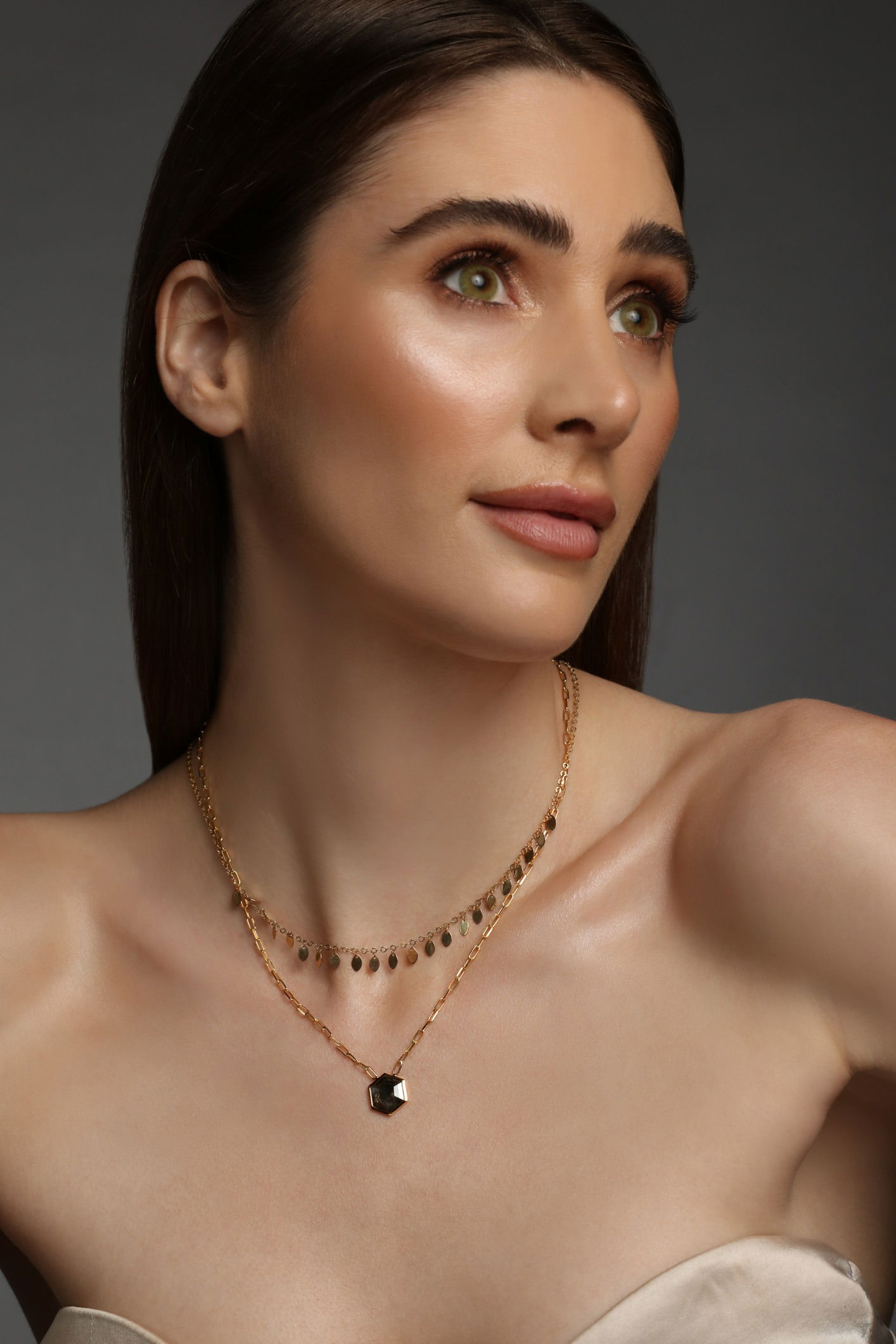 Close-up studio photograph of fine jewellery worn on model showing detail and craftsmanship