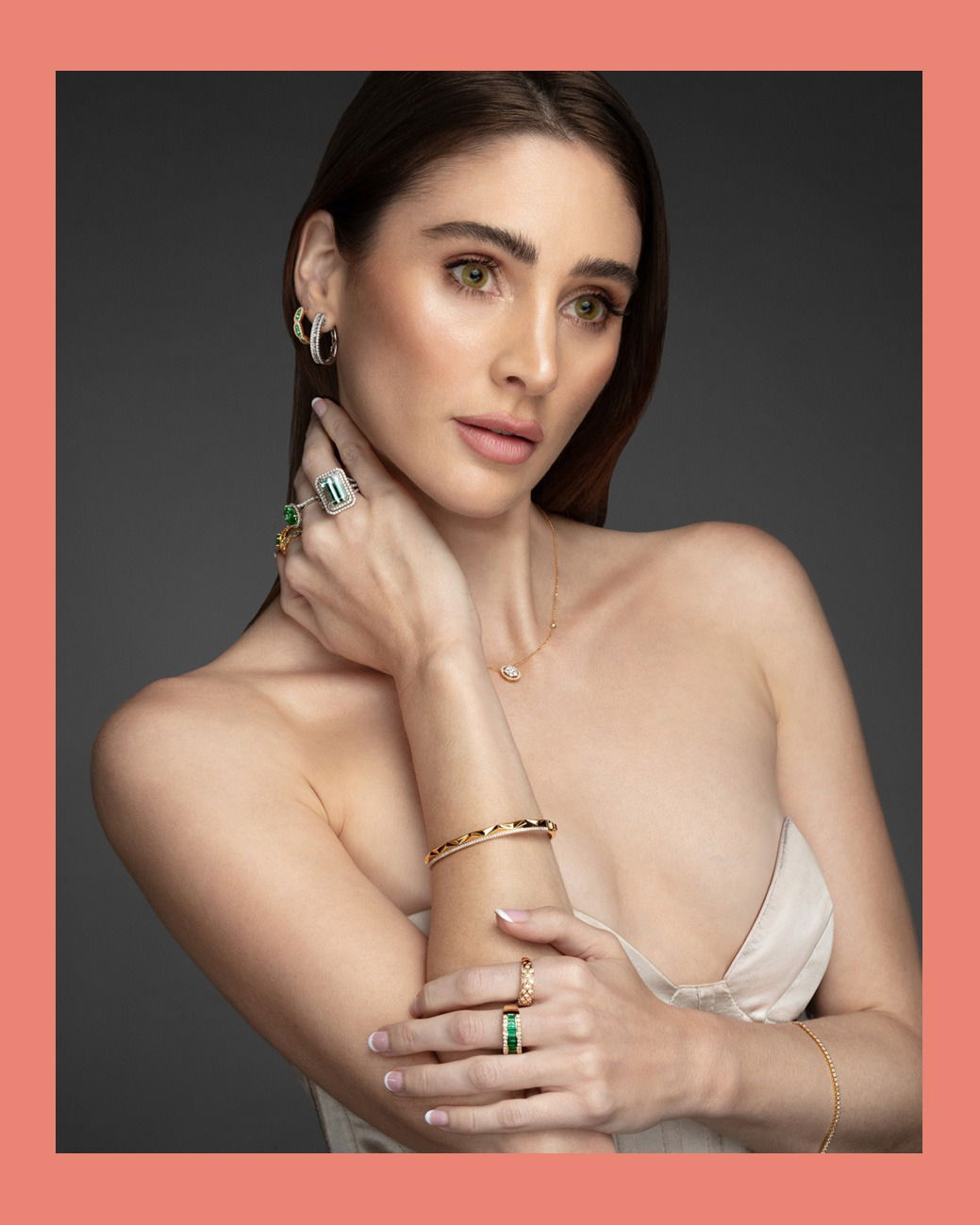 Studio photograph of model wearing a fine jewellery set with necklace, ring, and bracelet