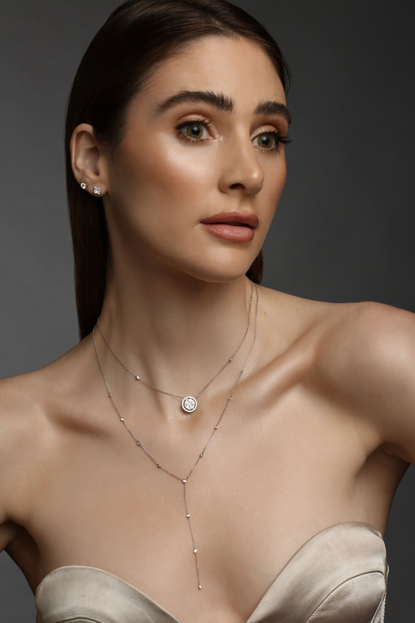Model wearing a fine jewellery set including necklace and earring photographed in studio