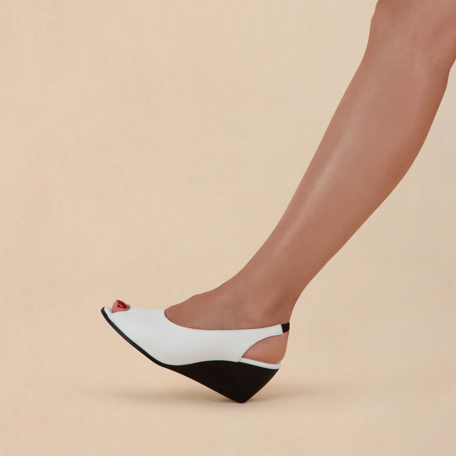 Half-body shot of a model wearing stylish fashion shoes.