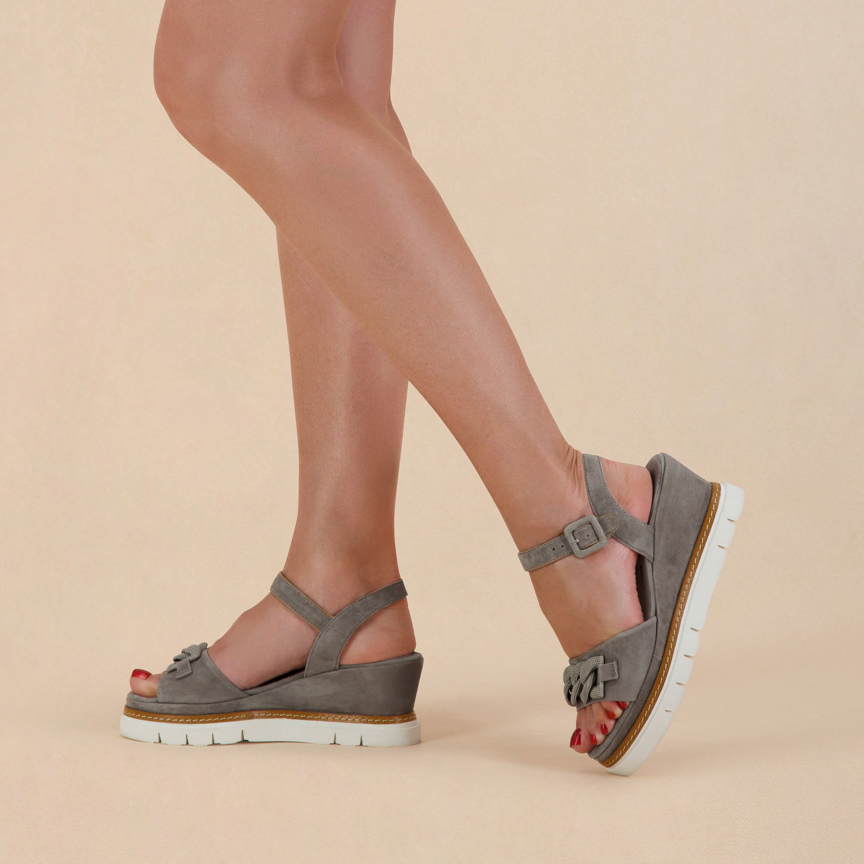 Half-body shot of a model wearing stylish fashion shoes.