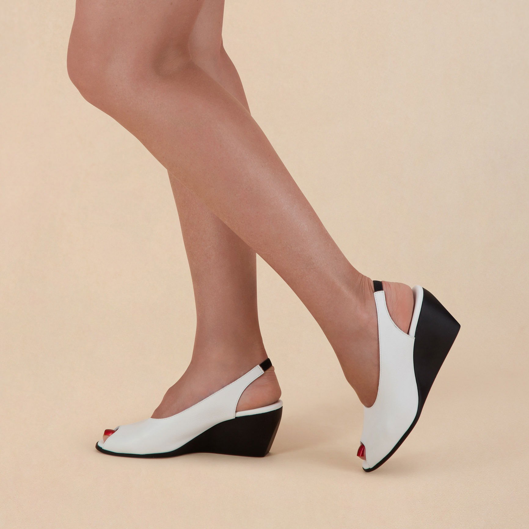 Half-body shot of a model wearing stylish fashion shoes.