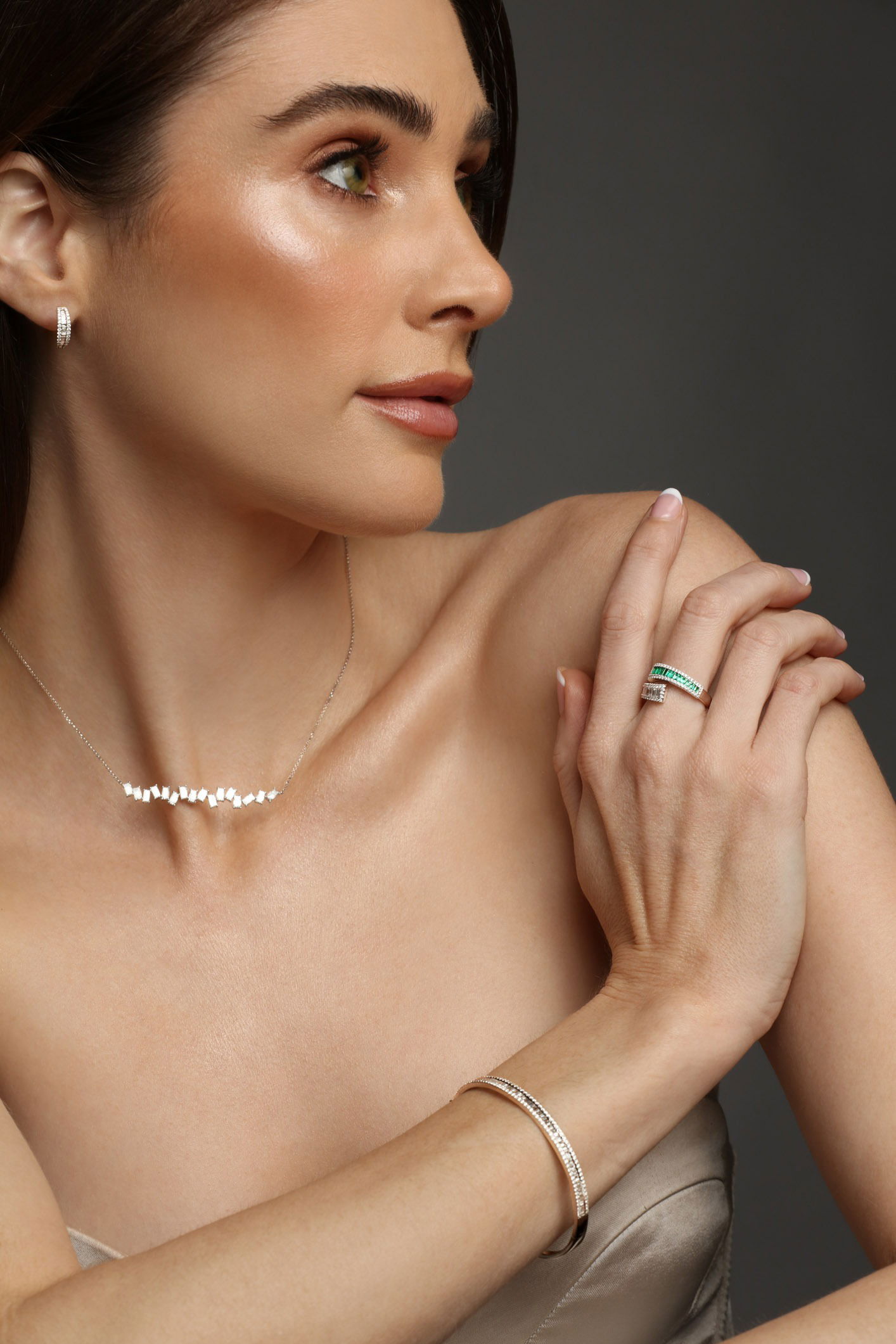 Luxury jewellery set with necklace, ring, bracelet and earring photographed on model in studio
