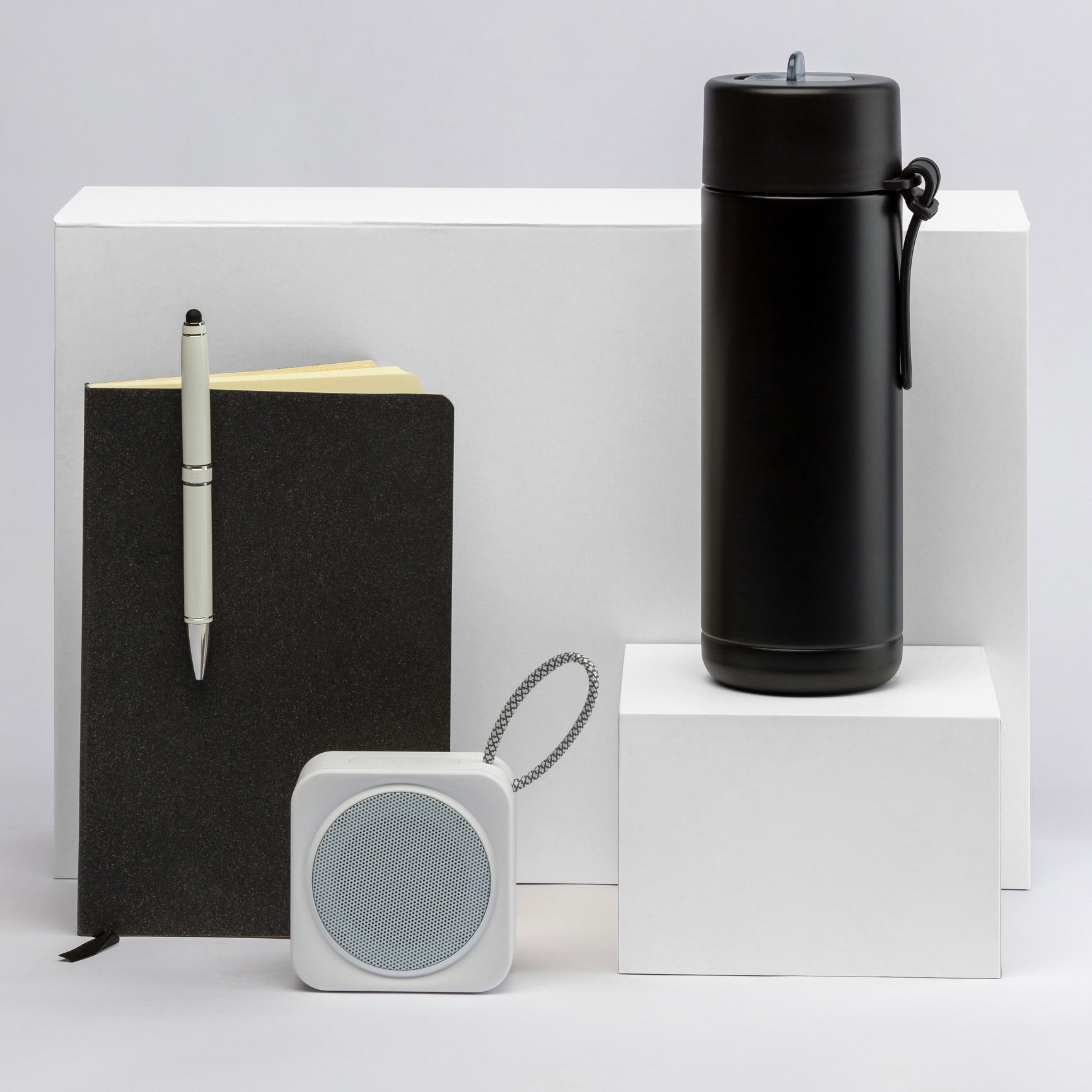 Gift set featuring a pen, notebook, and water bottle, photographed in a Brisbane studio with clean styling.