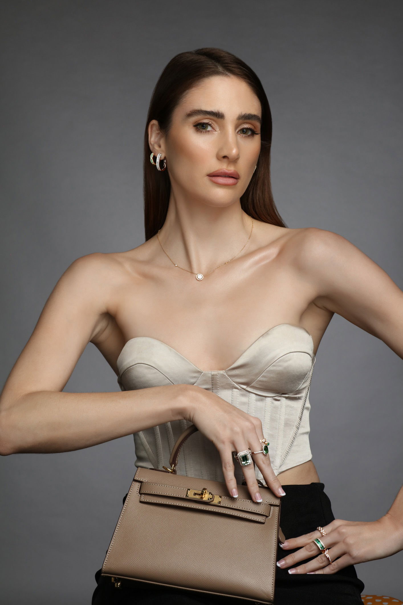 Model wearing a studio-photographed fine jewellery set with necklace, ring, and earring