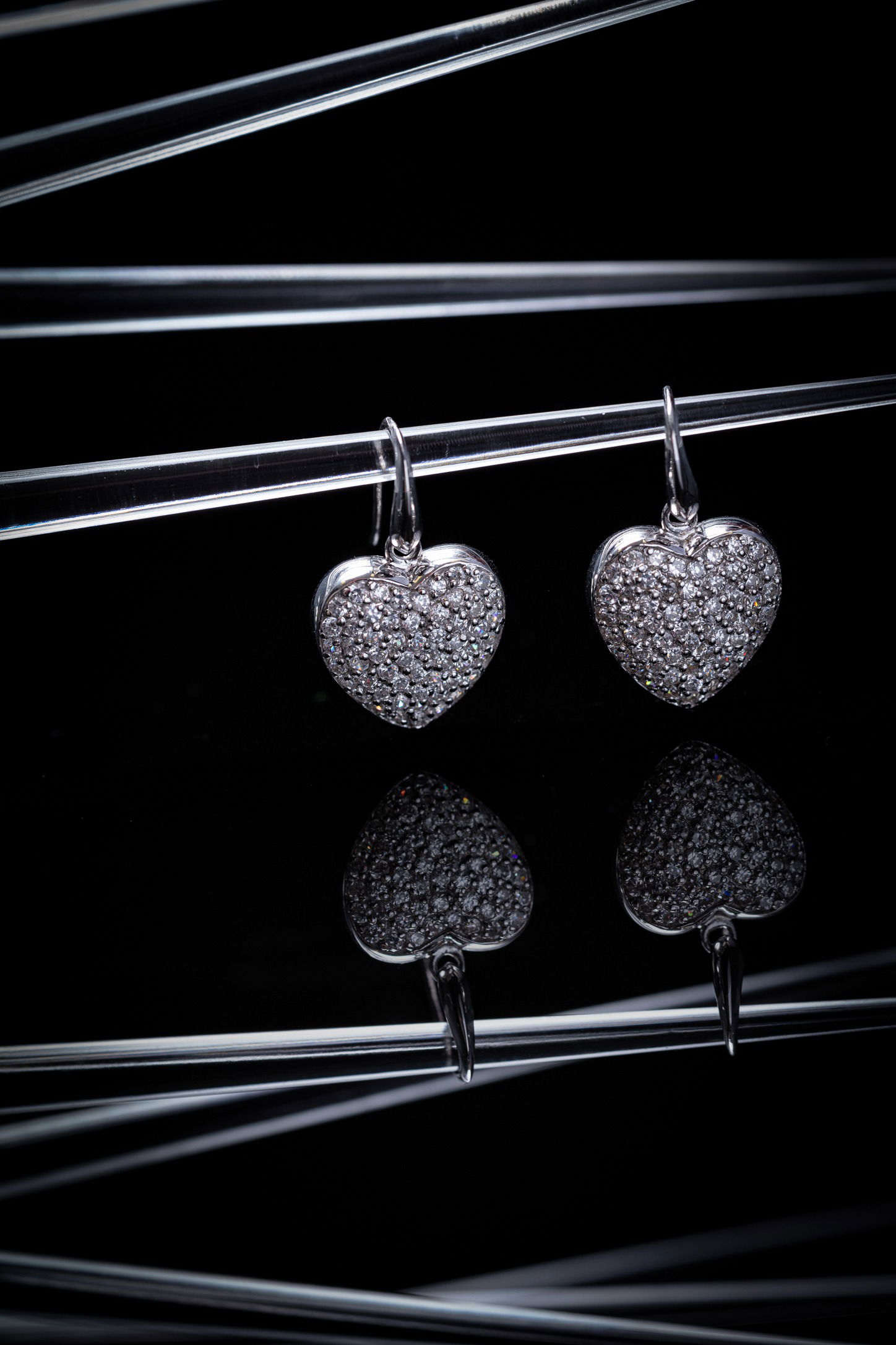 crystal heart earrings hanging from glass branches