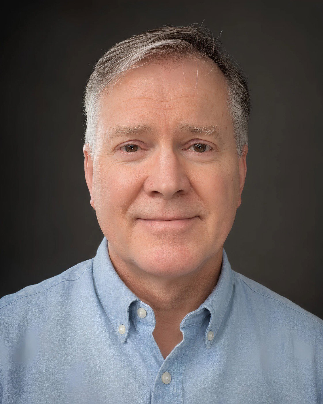 Portrait of Rich Rose wearing a light blue shirt